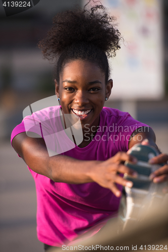 Image of African American woman doing warming up and stretching