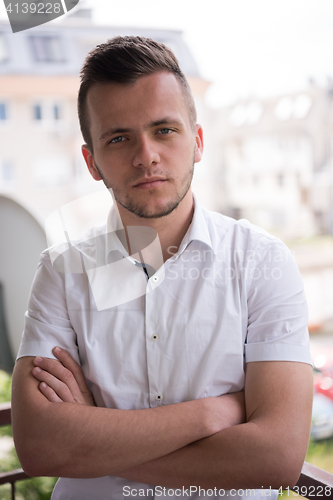 Image of man standing at balcony