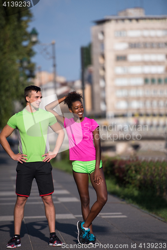 Image of portrait of young multietnic jogging couple ready to run