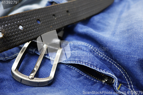 Image of Blue jeans with black leather belt