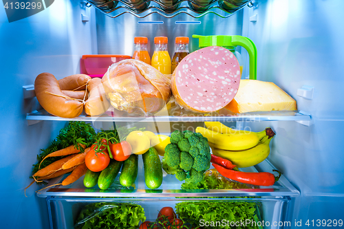 Image of Open refrigerator filled with food