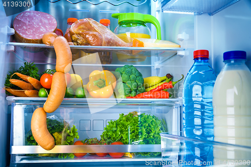 Image of Open refrigerator filled with food