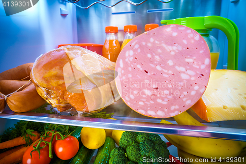 Image of Open refrigerator filled with food