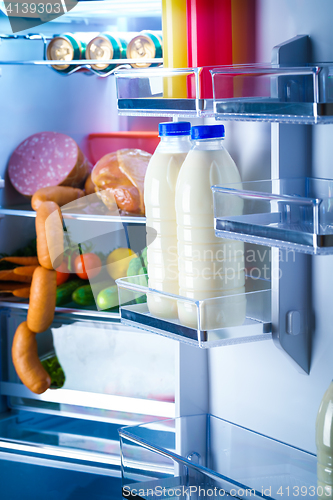 Image of Open refrigerator filled with food