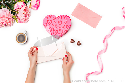 Image of The female hands with envelope on white background