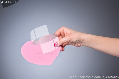 Image of Heart shape love symbol in woman hand