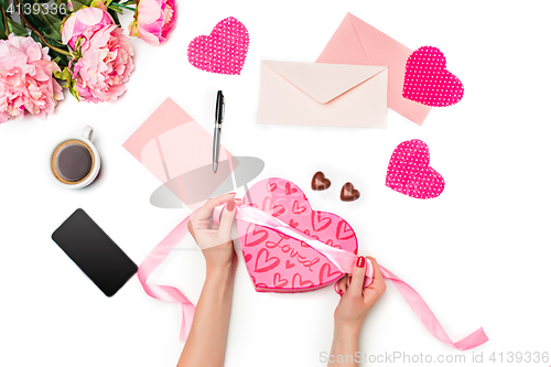 Image of The female hands with gift box on white background