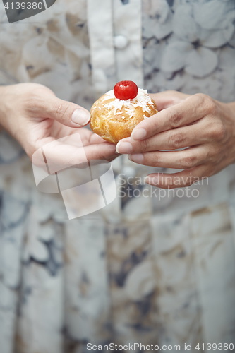 Image of Woman holding Christmas eclair