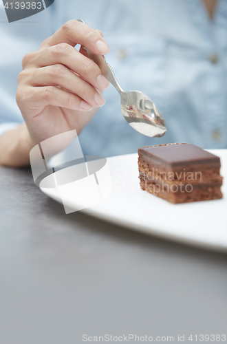 Image of Woman eating chocolate cake