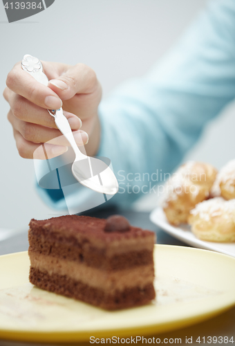 Image of Woman eating chocolate cake