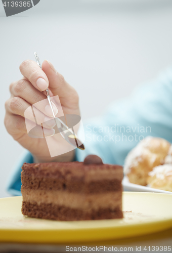 Image of Woman eating chocolate cake