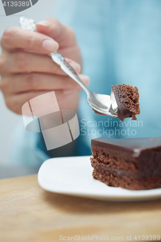 Image of Woman eating chocolate cake