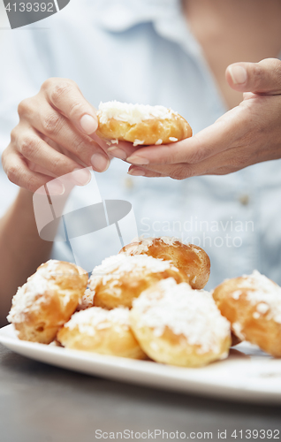 Image of Woman preparing eclairs at home