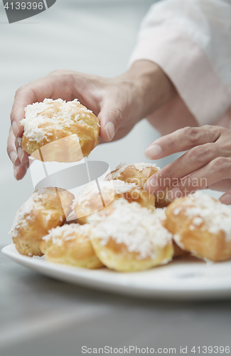 Image of Woman eating eclairs