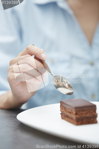 Image of Woman eating chocolate cake