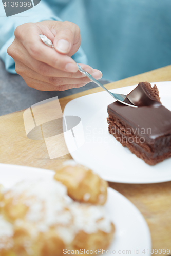 Image of Woman eating chocolate cake