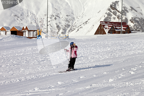 Image of Little skier at ski resort in sun winter day