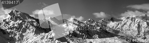 Image of Black and white panoramic view on snowy mountains in sunny day