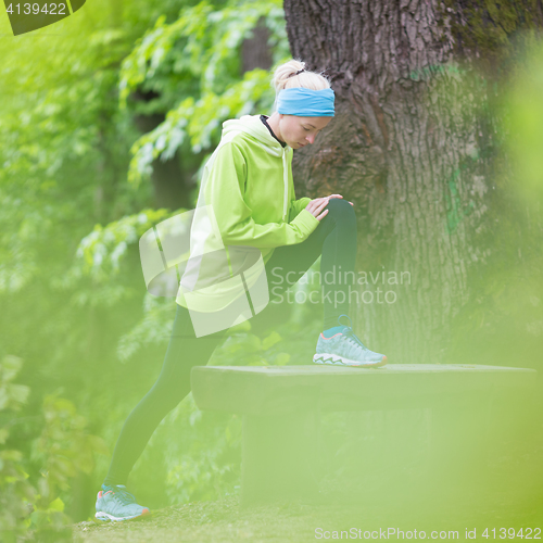Image of Sporty woman  working out in forest. 