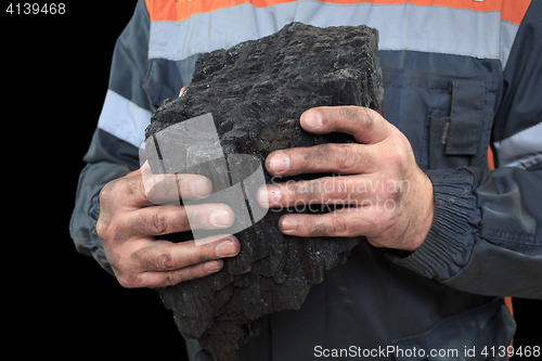 Image of Coal in the hands of a miner. close-up