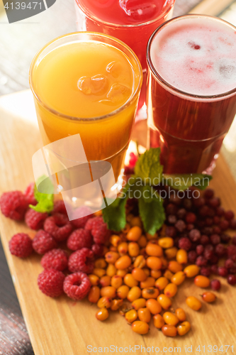 Image of fruit drink with cranberries raspberries and sea buckthorn