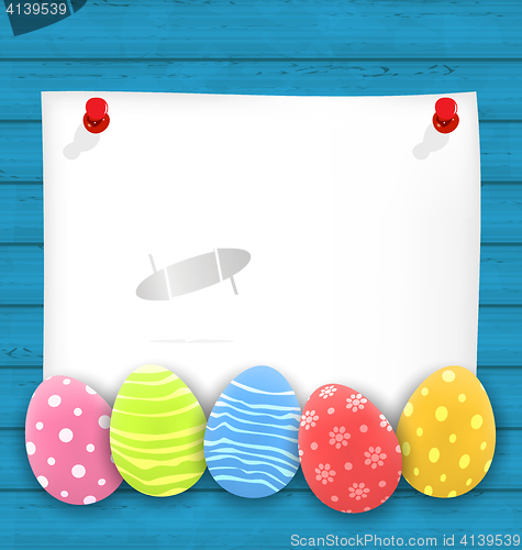 Image of Celebration empty paper card with Easter ornamental eggs on wood