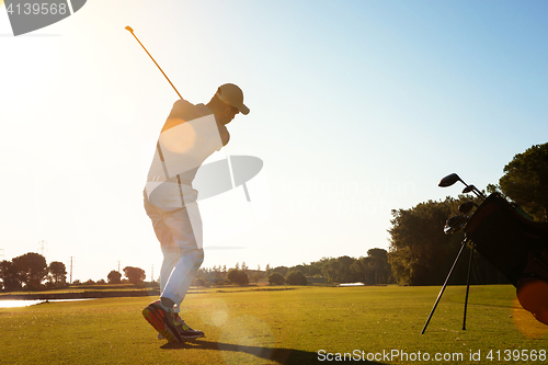 Image of golf player hitting shot with club