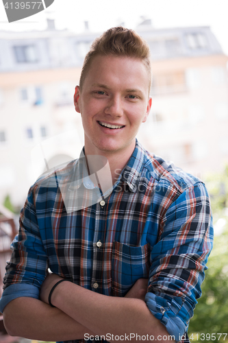 Image of man standing at balcony