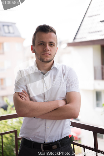 Image of man standing at balcony