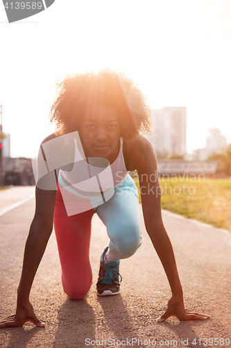 Image of Portrait of sporty young african american woman running outdoors