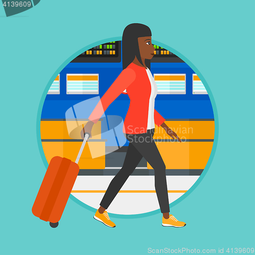 Image of Woman walking with suitcase at the airport.