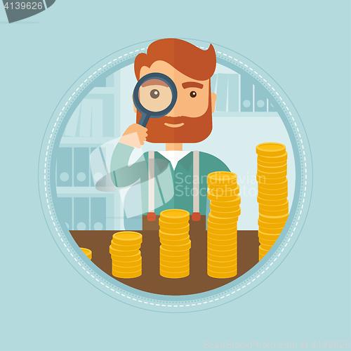 Image of Man looking through magnifier at golden coins.