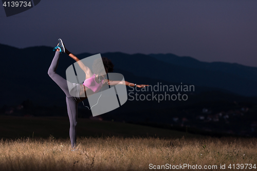 Image of black woman doing yoga  in the nature