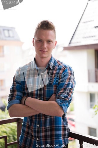 Image of man standing at balcony