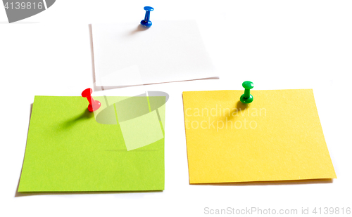 Image of Thumbtack pins and notepaper on white