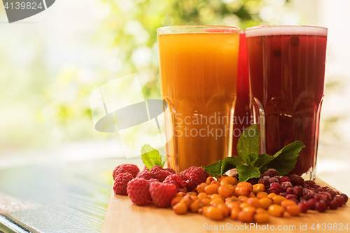 Image of fruit drink with cranberries raspberries and sea buckthorn