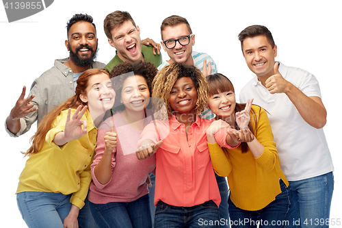 Image of international group of people showing thumbs up