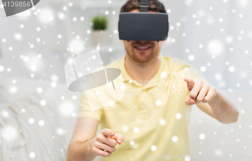 Image of young man in virtual reality headset or 3d glasses