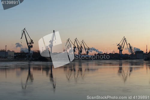 Image of  Silhouettes of of portal cranes on the horizon