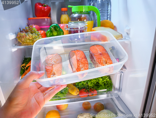 Image of Raw Salmon steak in the open refrigerator