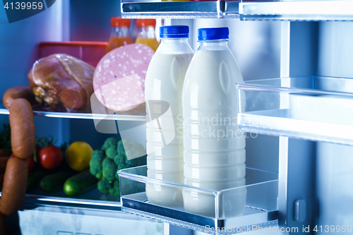 Image of Open refrigerator filled with food