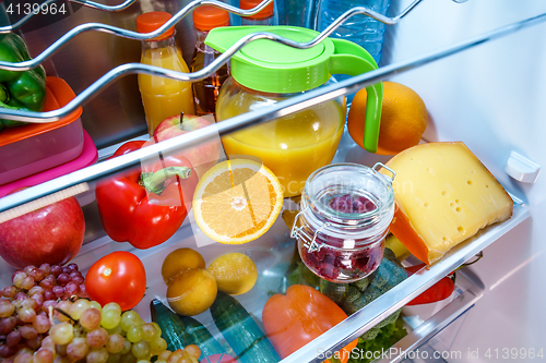 Image of Open refrigerator filled with food