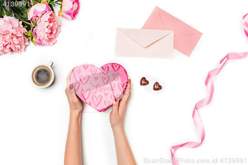 Image of The female hands with gift box on white background