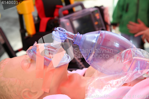 Image of Practicing to use an oxygen mask on training doll