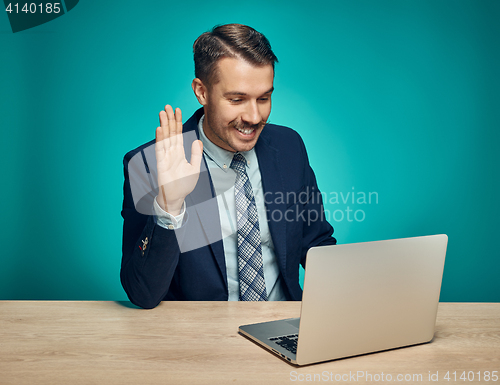 Image of Sad Young Man Working On Laptop At Desk