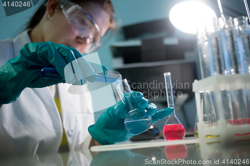 Image of Technician with flasks and tubes