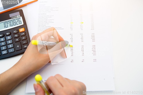 Image of Woman working with paperwork, reports