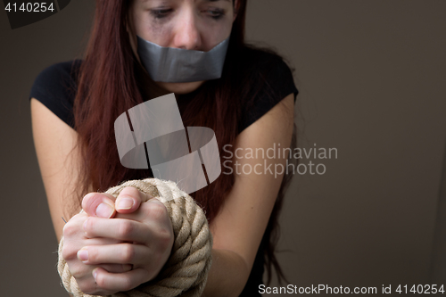 Image of Victim woman with tied hands