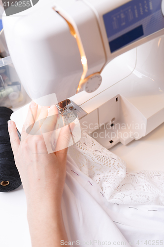 Image of Dressmaker doing lines on sewing-machine