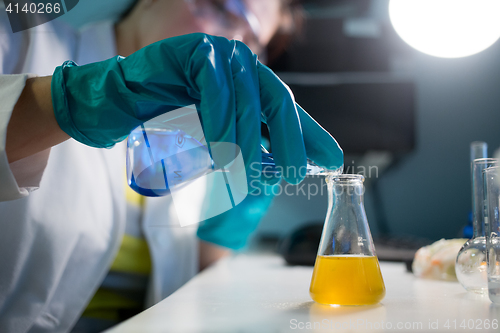 Image of Laboratory assistant carries chemical experiments
